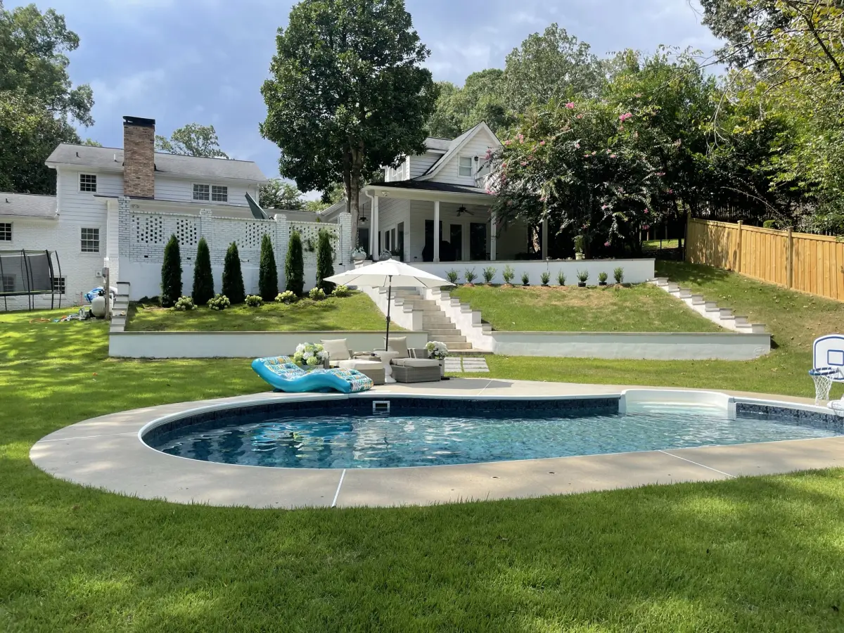 Close-up of pool deck and shaped shrubs